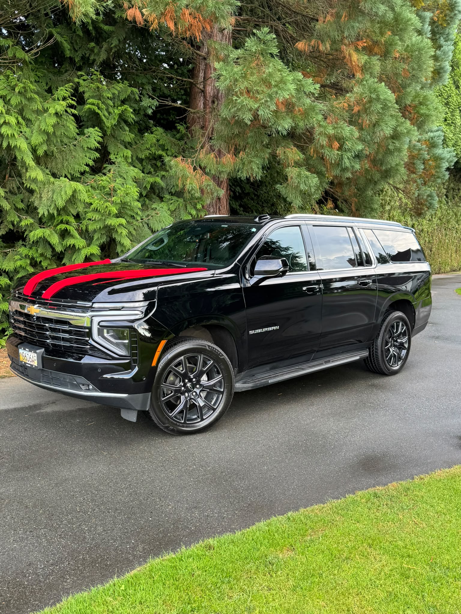 Blackline black Chevrolet Suburban with red stripes